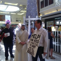 Father Chris Bedding  Holy Family greet shoppers at Garden City