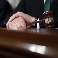 Econs Brush with the Law