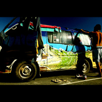Wicked vans  dirty slogans parked next to a school