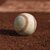 Weather is windy and warm, baseball is near