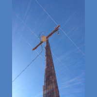 Electricity going through an electrical post, at night in the desert.