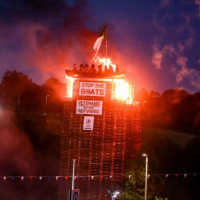 A loyalist bonfire with an effigy of migrants in a boat has been lit
