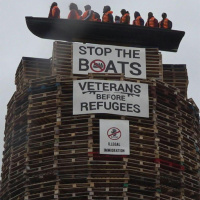 Loyalist bonfire containing an effigy of migrants condemned
