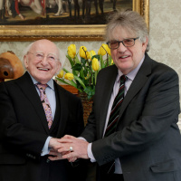 President Higgins confers the Torc, Symbol of the Office of Saoi, on Paul Muldoon