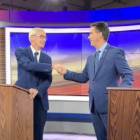 Who won the first Walker/Evers debate?